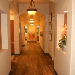 Hallway with flowers, a photo and a painting